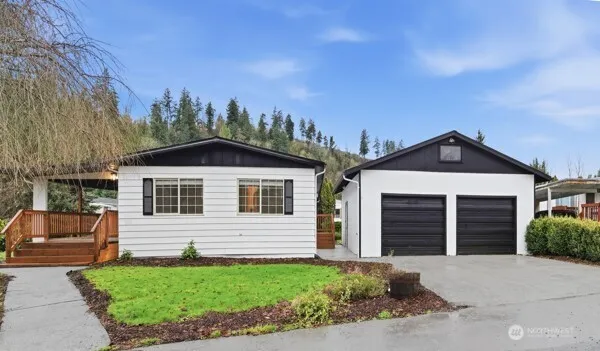 a front view of a house with a yard and garage