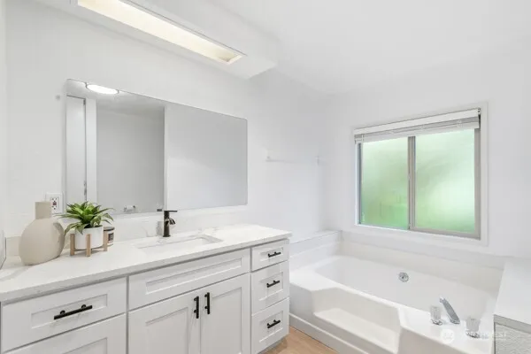a bathroom with a granite countertop sink a toilet and bathtub