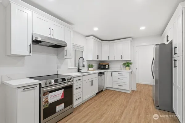 a kitchen with a sink cabinets and window