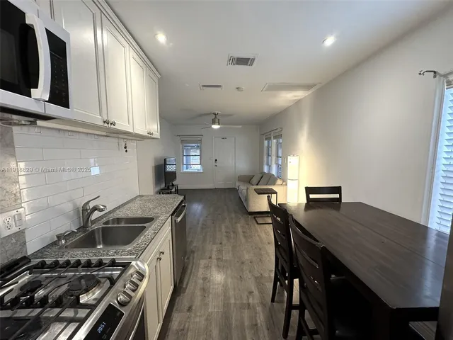 a kitchen with a stove a sink and a stove