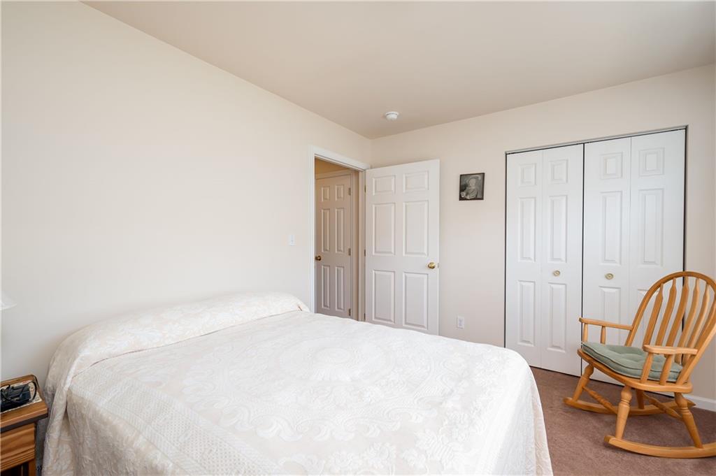 192 Wood Hawk Lane Butler, PA 16001 - Photo 18 of 23 a bedroom with a bed and chair