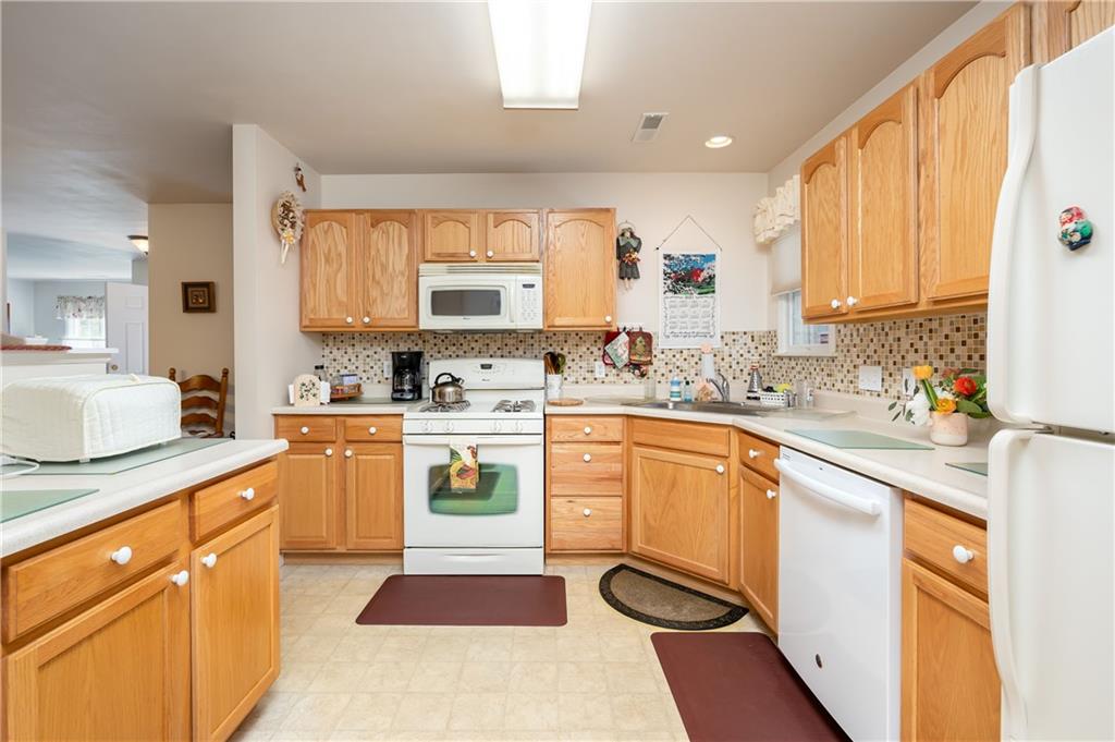 192 Wood Hawk Lane Butler, PA 16001 - Photo 7 of 23 a kitchen with stainless steel appliances kitchen island granite countertop a sink a stove cabinets counter space and a window