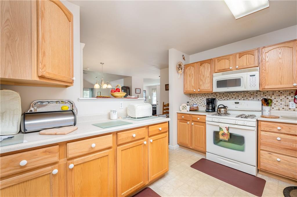 192 Wood Hawk Lane Butler, PA 16001 - Photo 9 of 23 a kitchen with granite countertop white cabinets and white appliances
