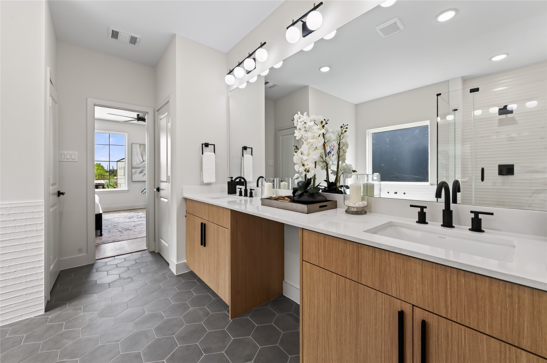 14107 Bridgeport Road Houston, TX 77047 - Photo 23 of 38 Luxurious primary bathroom is elegant as it is grand.