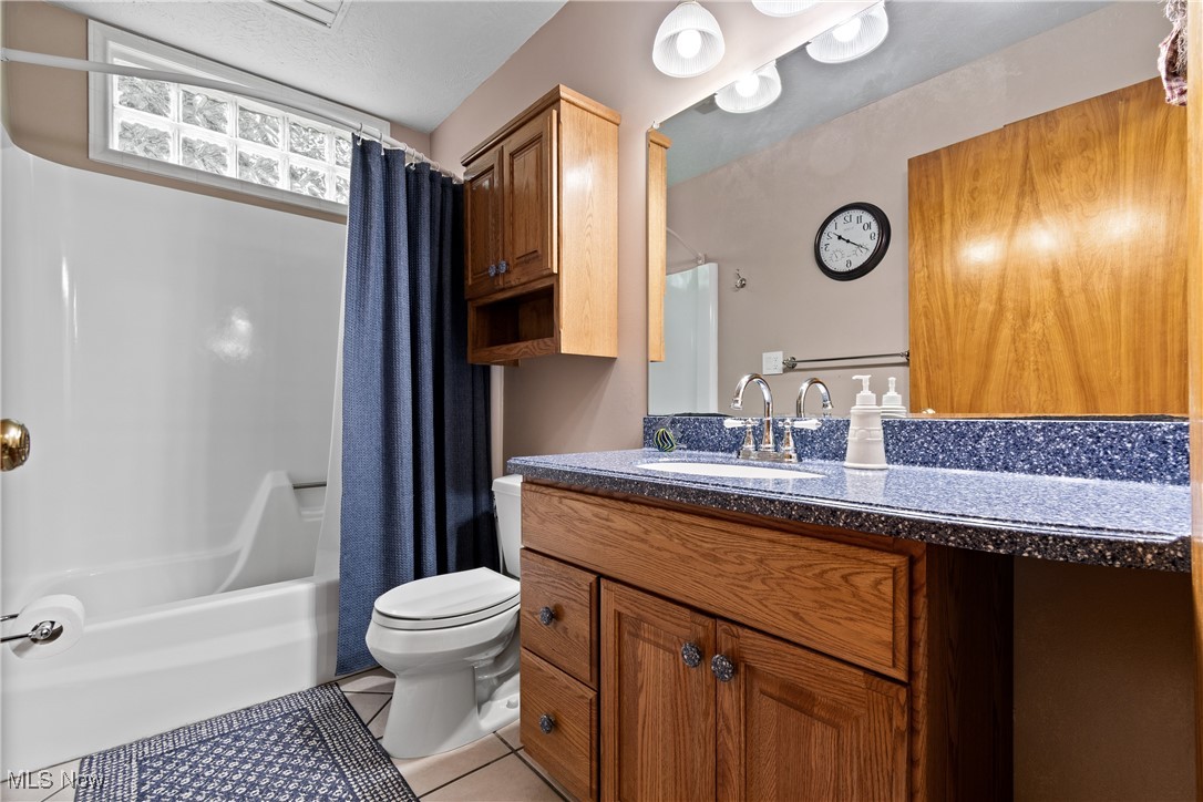 4640 Sherman Road Kent, OH 44240 - Photo 22 of 37 Full bath featuring tile patterned flooring, vanity, and shower / bath combination with curtain