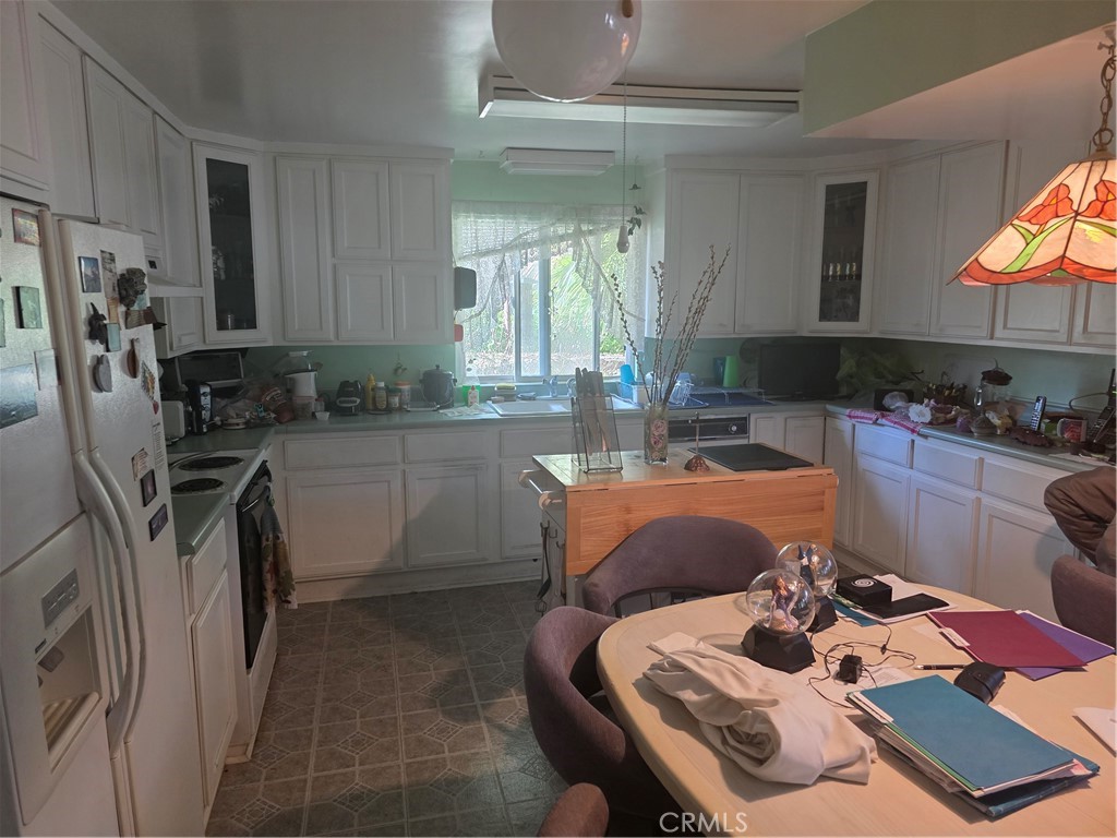 9341 Rollins Road Chatsworth, CA 91311 - Photo 6 of 15 a kitchen with a sink appliances and cabinets