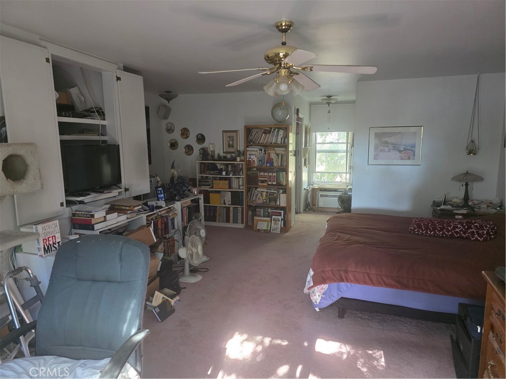 9341 Rollins Road Chatsworth, CA 91311 - Photo 10 of 15 a bedroom with furniture a chandelier and a window