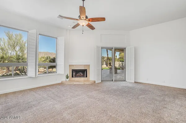 a view of an empty room with a ceiling fan