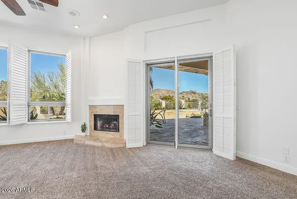 en empty room with windows and chandelier
