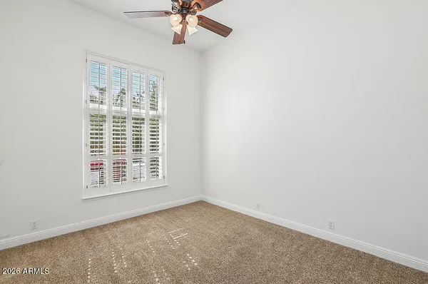 a bathroom with a granite countertop sink a mirror and a shower