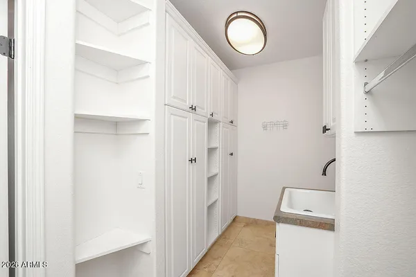 a bathroom with a granite countertop toilet a sink and mirror
