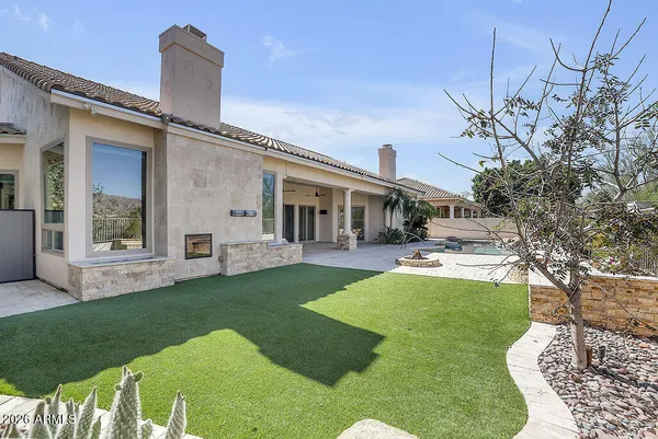 an aerial view of a house with a garden and lake view
