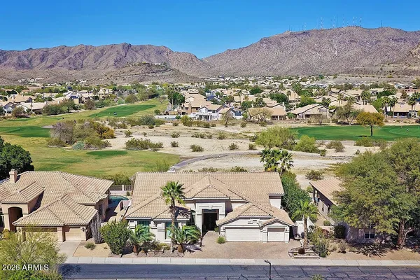 a aerial view of a house with a yard and potted plants