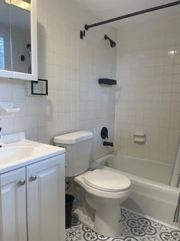 a bathroom with a sink a toilet and mirror