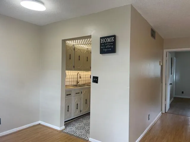 a view of a hallway with wooden floor