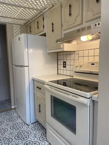 a kitchen with stainless steel appliances a refrigerator stove and cabinets