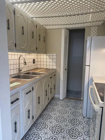 a spacious bathroom with a granite countertop sink and a mirror