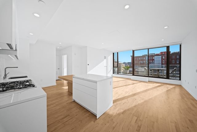 a living room with furniture a large window and gym equipment
