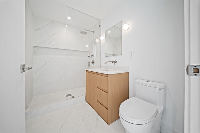 a spacious bathroom with a toilet sink and shower