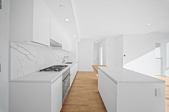 a kitchen with stainless steel appliances a stove and a refrigerator