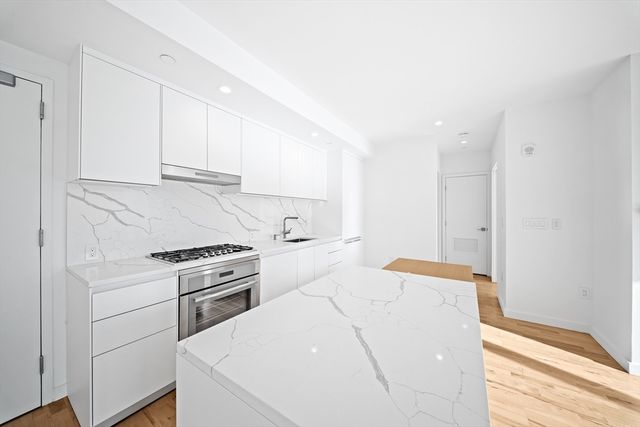 a kitchen with a stove and a refrigerator