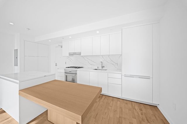 a kitchen with a refrigerator a sink and cabinets