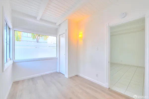 a spacious bathroom with a granite countertop sink a bathtub and window