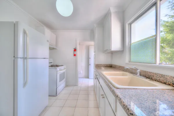 a bathroom with a sink a light fixture and a mirror