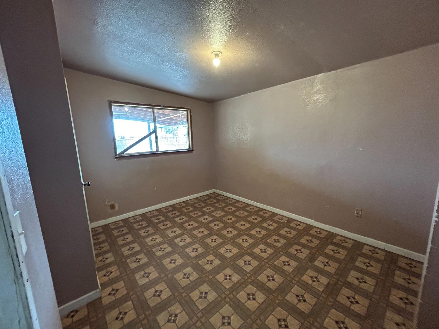 236 K Street Sanger, CA 93657 - Photo 13 of 23 an empty room with windows