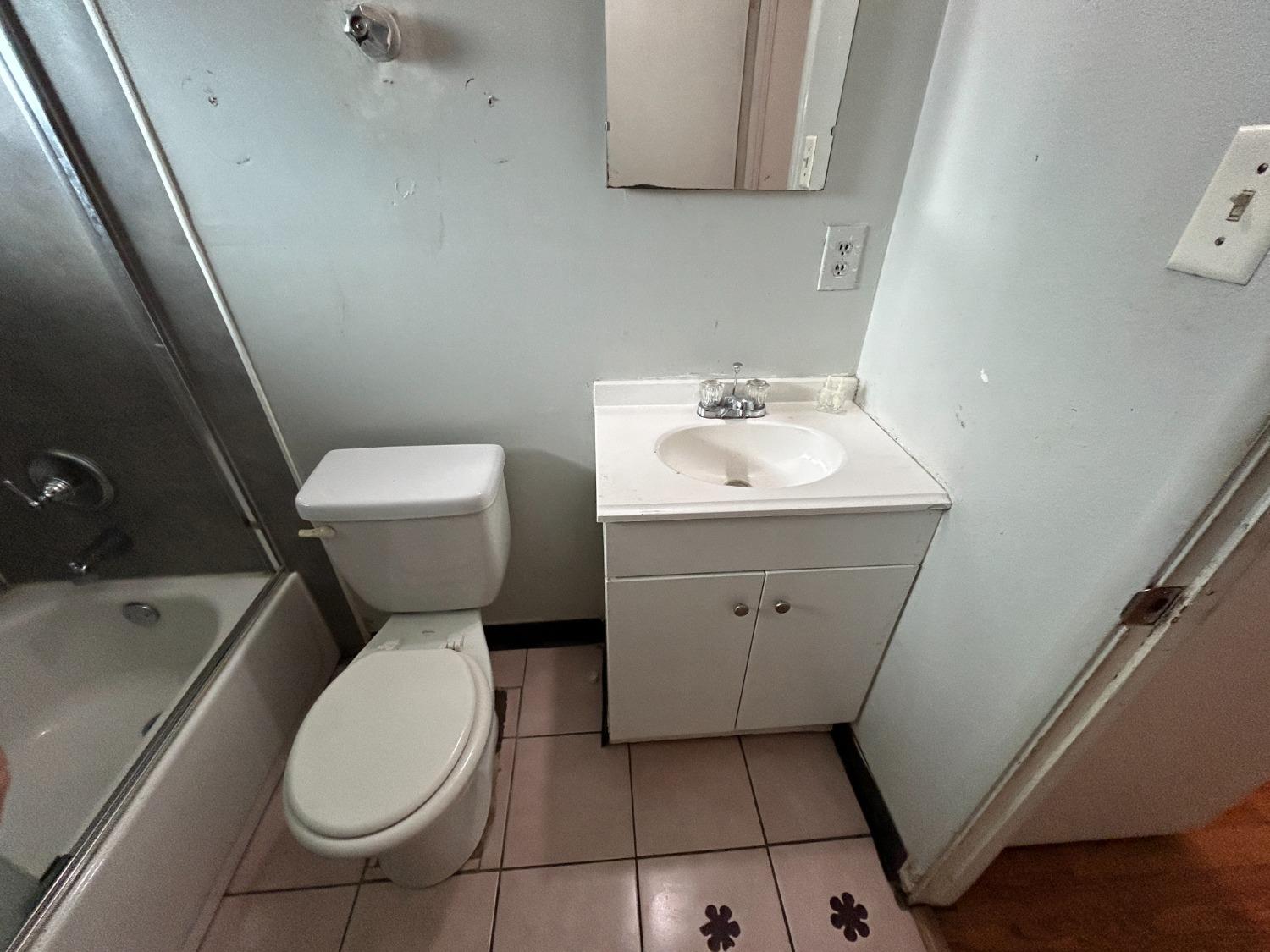 236 K Street Sanger, CA 93657 - Photo 10 of 23 a white toilet sitting next to a bathroom sink