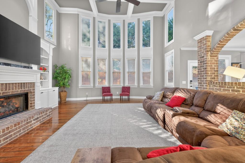 8023 Sleepy Lagoon Way Flowery Branch, GA 30542 - Photo 12 of 79 a living room with furniture and a fireplace