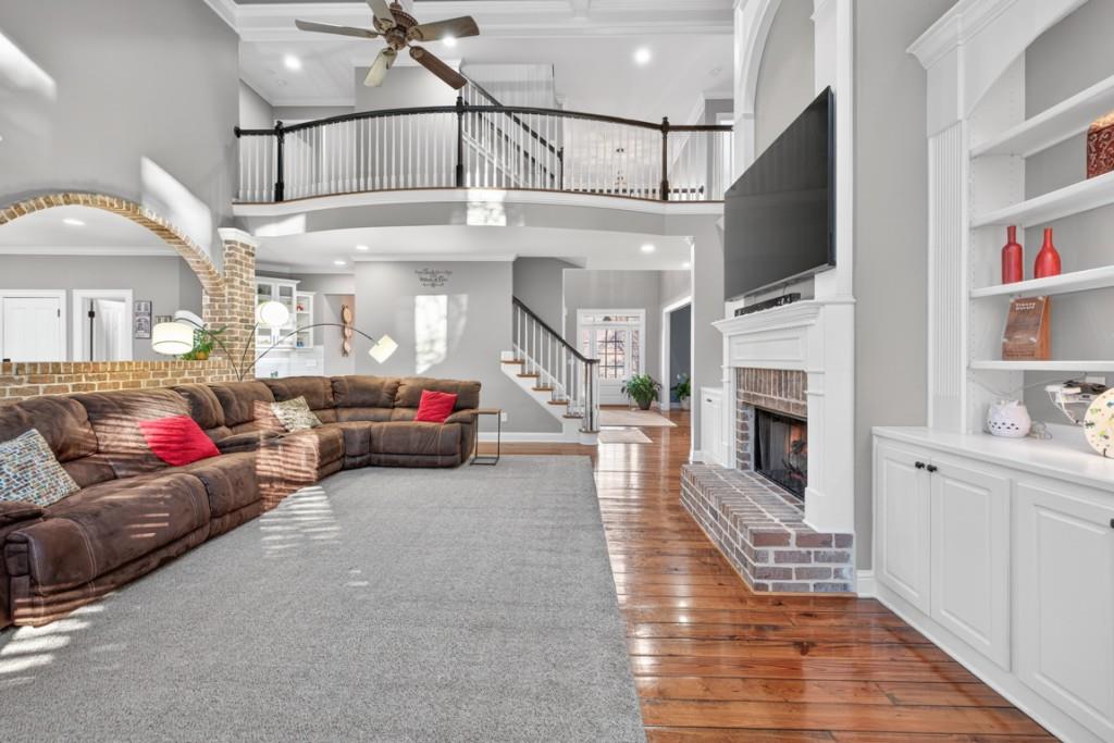 8023 Sleepy Lagoon Way Flowery Branch, GA 30542 - Photo 14 of 79 a living room with furniture and a fireplace
