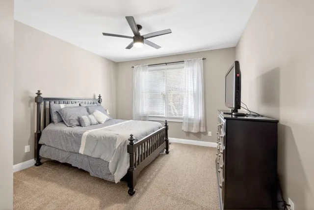 a living room with furniture a rug and white walls