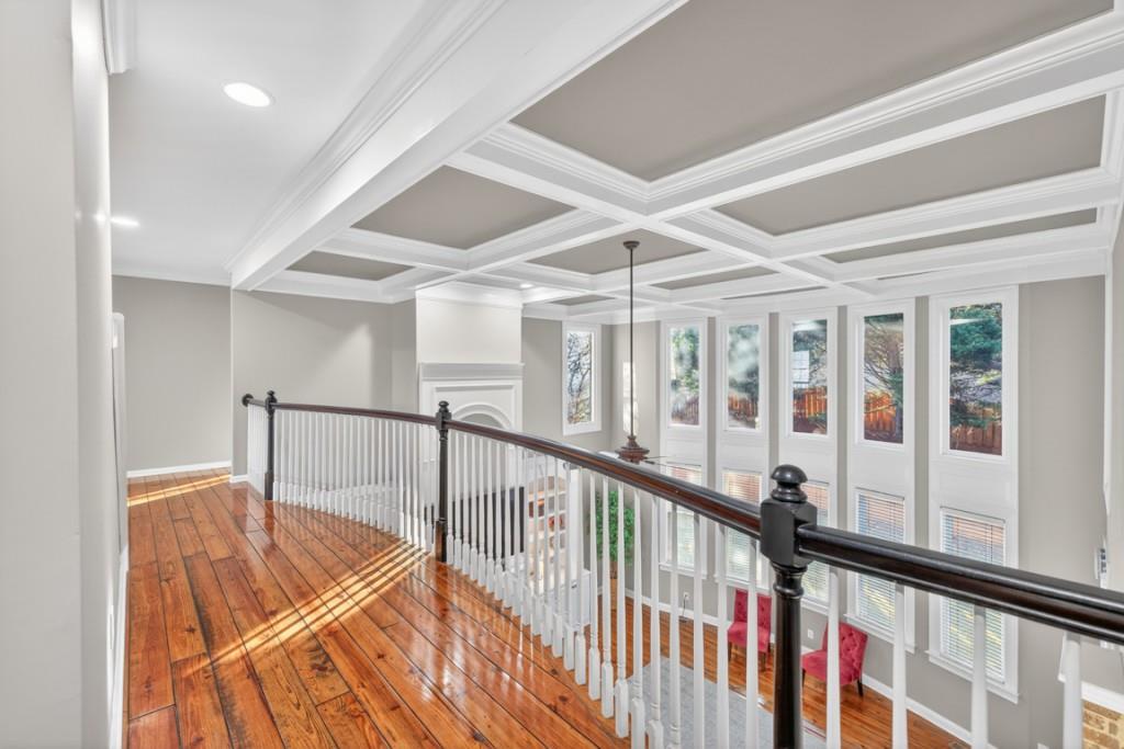 8023 Sleepy Lagoon Way Flowery Branch, GA 30542 - Photo 26 of 79 a view of staircase with lots of frames on wall and a large window