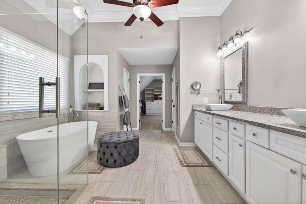 8023 Sleepy Lagoon Way Flowery Branch, GA 30542 - Photo 29 of 79 a spacious bathroom with a double vanity sink a mirror and a bathtub