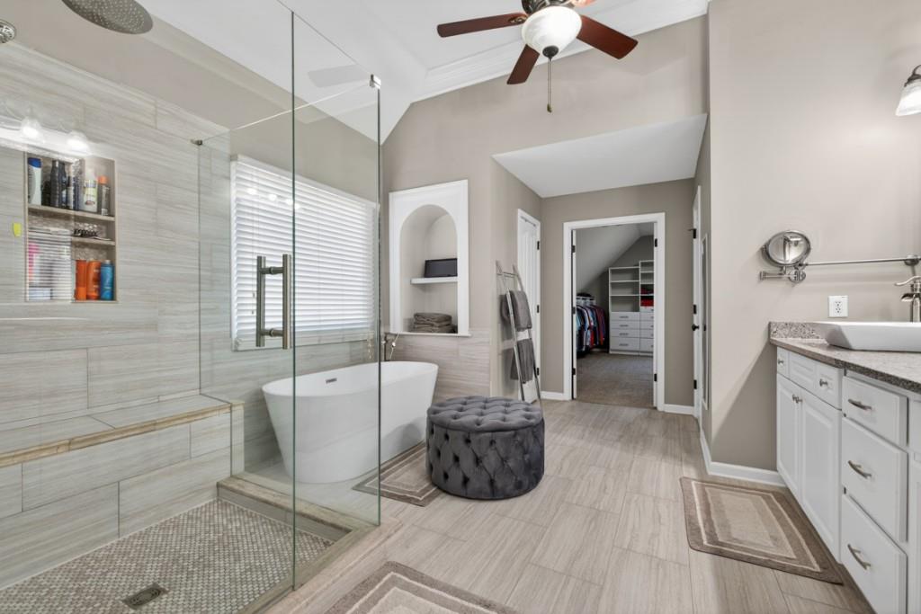 8023 Sleepy Lagoon Way Flowery Branch, GA 30542 - Photo 30 of 79 a spacious bathroom with a double vanity sink a mirror and a bathtub