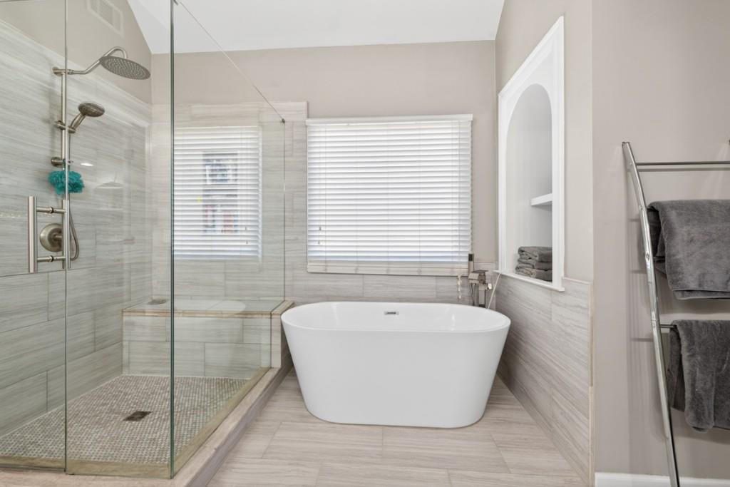 8023 Sleepy Lagoon Way Flowery Branch, GA 30542 - Photo 34 of 79 a white bath tub sitting next to a shower