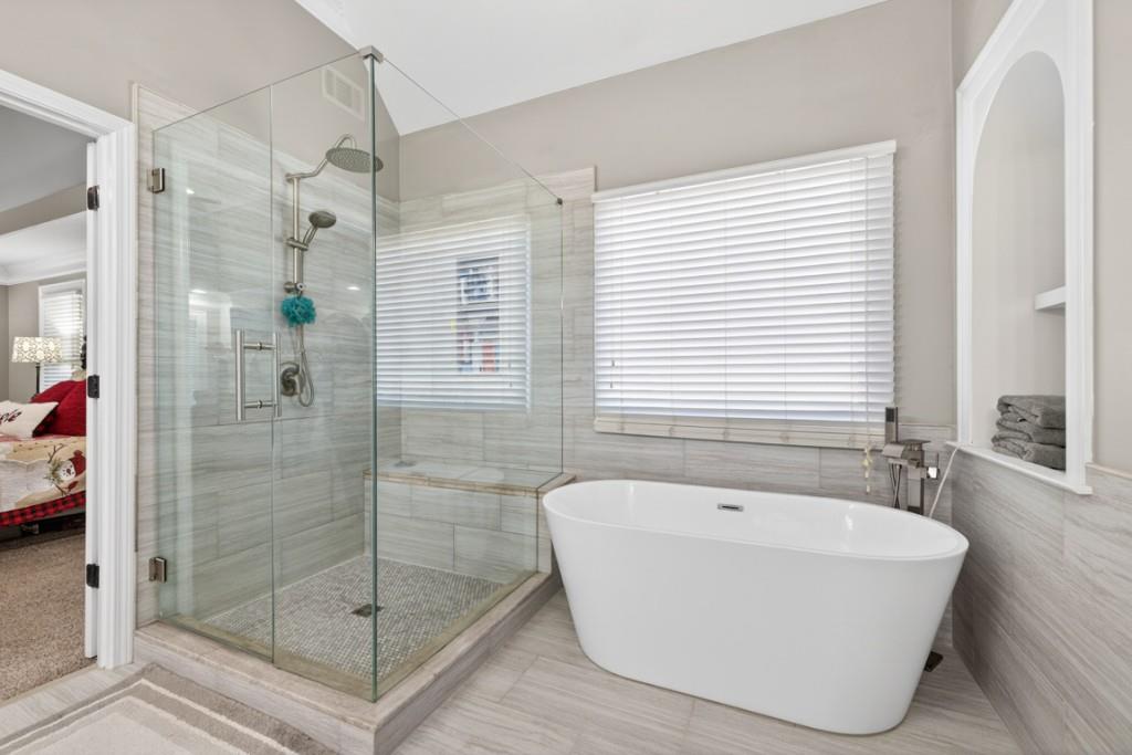 8023 Sleepy Lagoon Way Flowery Branch, GA 30542 - Photo 35 of 79 a white bath tub sitting next to a shower