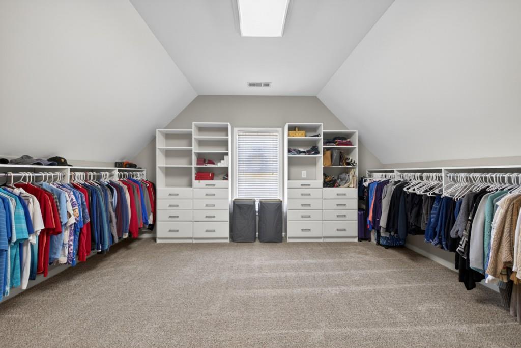 8023 Sleepy Lagoon Way Flowery Branch, GA 30542 - Photo 37 of 79 a view of walk in closet with clothes and shoes