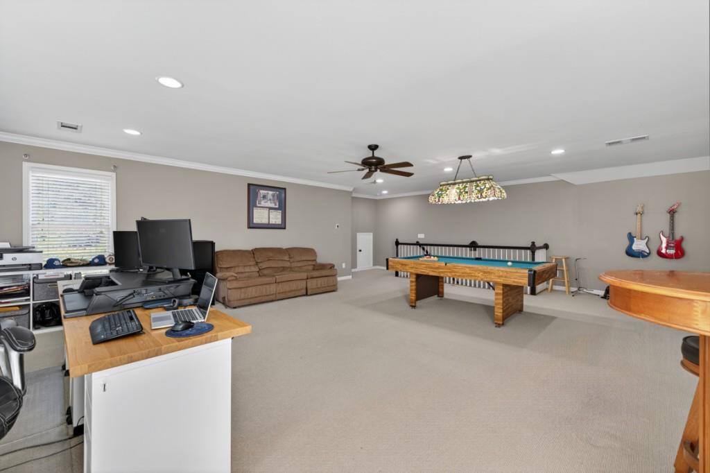 8023 Sleepy Lagoon Way Flowery Branch, GA 30542 - Photo 46 of 79 a living room with furniture and a flat screen tv