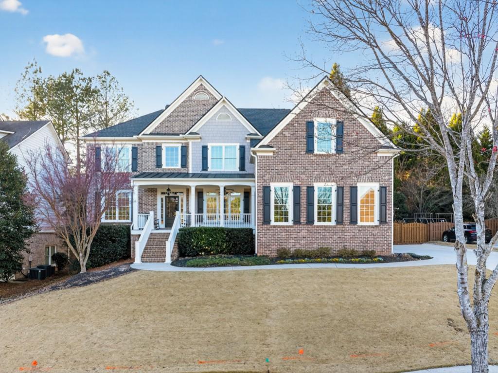 8023 Sleepy Lagoon Way Flowery Branch, GA 30542 - Photo 56 of 79 a front view of a house with a yard and garage
