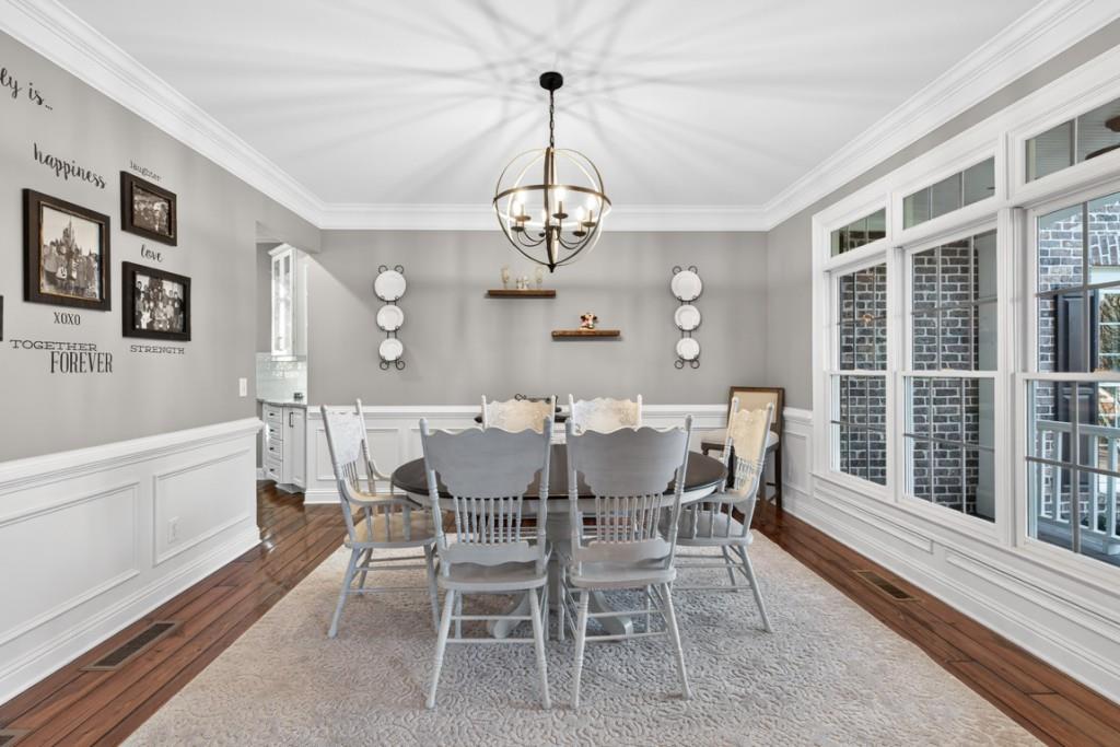 8023 Sleepy Lagoon Way Flowery Branch, GA 30542 - Photo 9 of 79 a view of a dining room with furniture wooden floor and chandelier