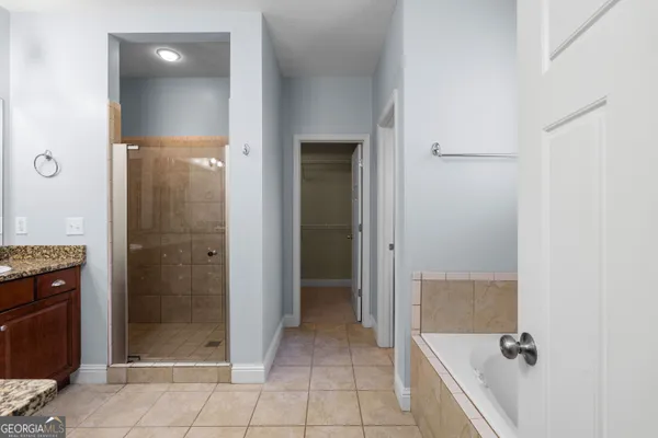 a bathroom with a tub a toilet and a shower