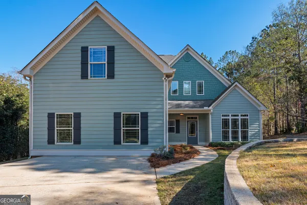 a front view of house with yard outdoor seating and garage