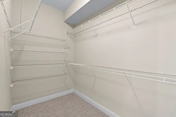 a view of an empty room and wooden floor