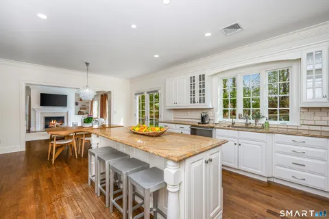 a kitchen that has a table and chairs in it