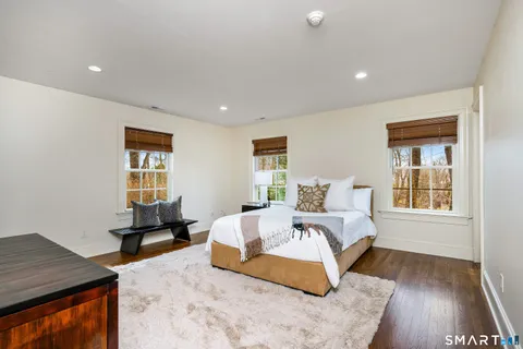 a spacious bedroom with a large bed and a window