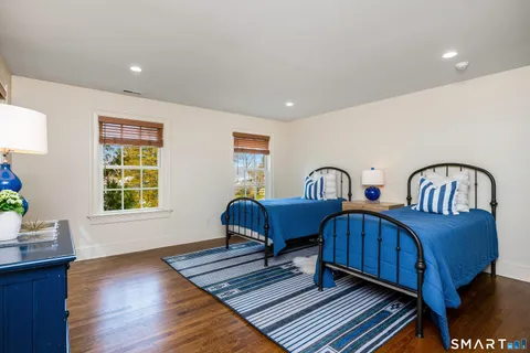 a bedroom with two beds and a window