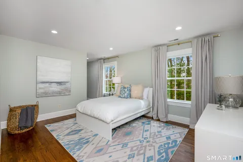a bedroom with a large bed and a window
