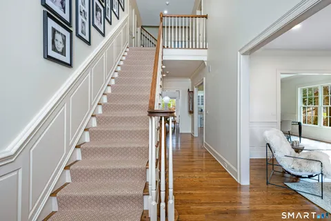 a view of entryway and hall with wooden floor